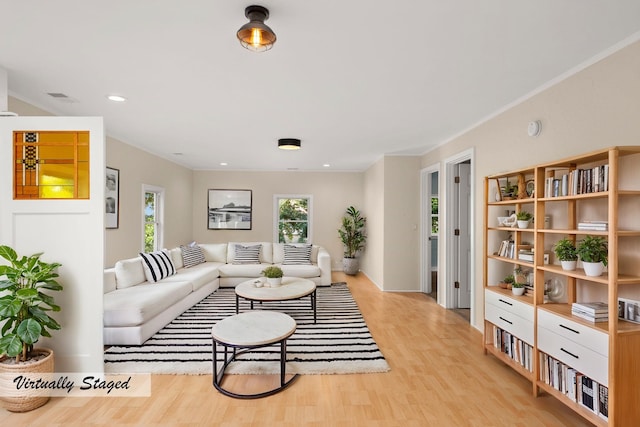 living room with recessed lighting, visible vents, and light wood-style flooring