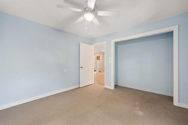 unfurnished bedroom featuring light carpet and a ceiling fan