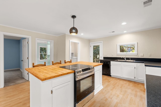 kitchen with decorative light fixtures, stainless steel electric stove, butcher block counters, white cabinetry, and dishwasher