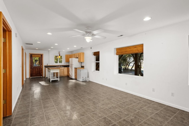 unfurnished living room featuring recessed lighting, visible vents, and baseboards