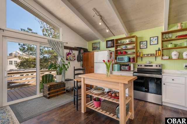 kitchen featuring stainless steel appliances, lofted ceiling, light countertops, dark wood-type flooring, and white cabinetry