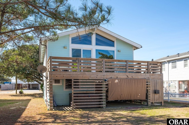 view of front facade featuring fence and a wooden deck