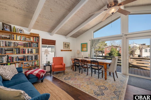 living area with ceiling fan, high vaulted ceiling, dark wood finished floors, and beam ceiling