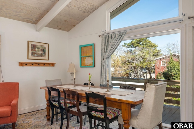 dining room with vaulted ceiling with beams, plenty of natural light, wood ceiling, and baseboards