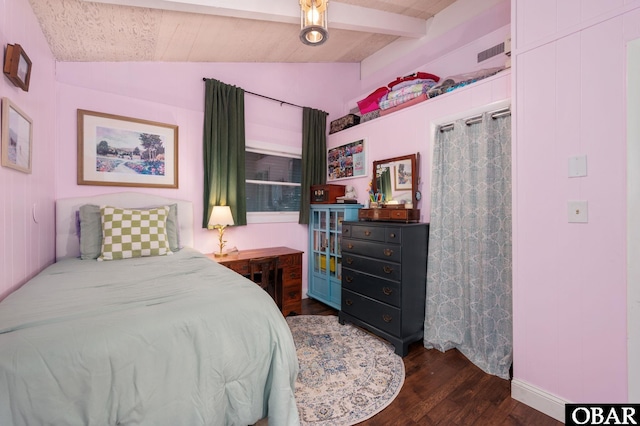 bedroom with lofted ceiling with beams, dark wood-style flooring, and visible vents