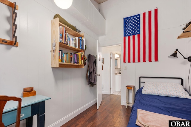 bedroom featuring dark wood-style floors and baseboards