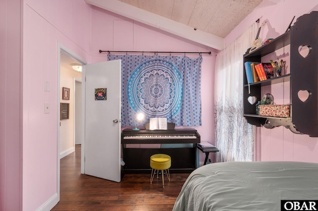 bedroom with lofted ceiling with beams and dark wood-style floors