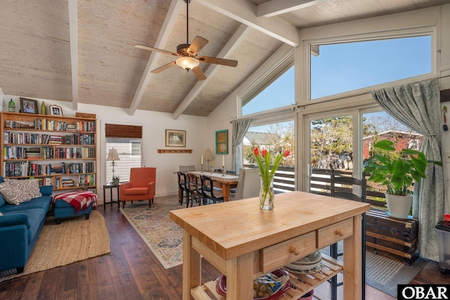 dining space with high vaulted ceiling, beam ceiling, ceiling fan, and dark wood-style flooring