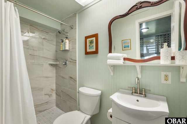 bathroom with vanity, a shower stall, and toilet