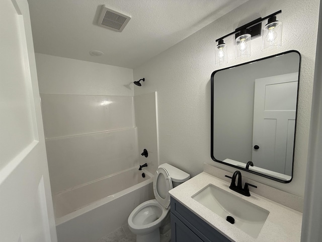 bathroom featuring visible vents, a textured wall, toilet, tub / shower combination, and vanity