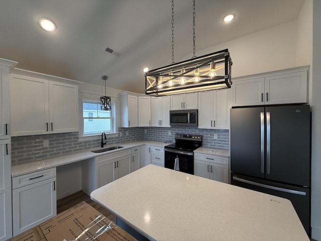 kitchen featuring pendant lighting, white cabinetry, a sink, and black appliances