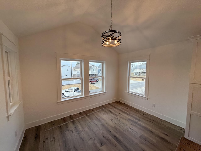 unfurnished dining area with lofted ceiling, baseboards, and dark wood-type flooring