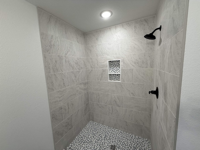 full bath with a tile shower