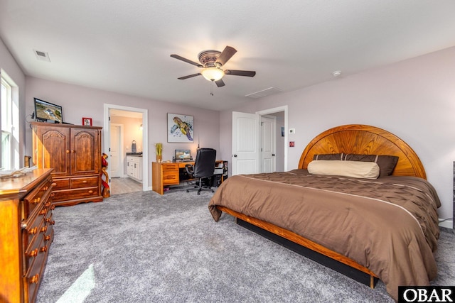 bedroom featuring visible vents, ensuite bath, ceiling fan, and carpet flooring