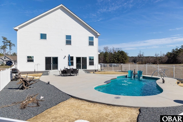 rear view of property with a fenced in pool, a patio, and a fenced backyard