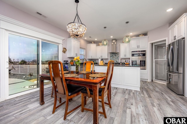 dining space with recessed lighting, visible vents, and light wood-style flooring