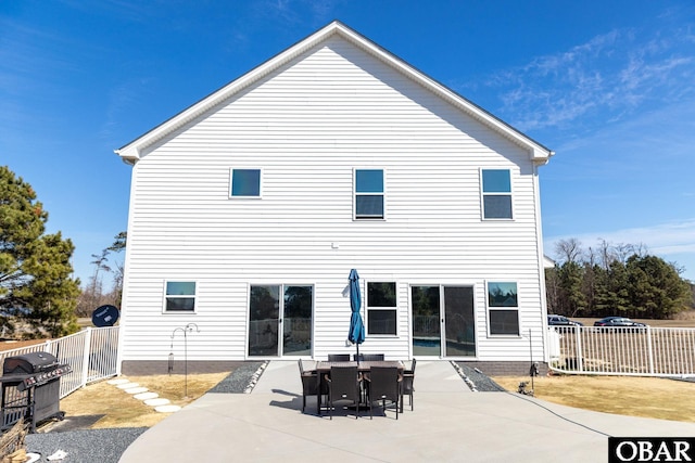 back of property featuring fence and a patio area