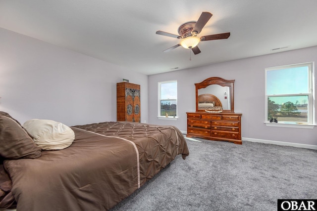 carpeted bedroom featuring visible vents, a ceiling fan, and baseboards