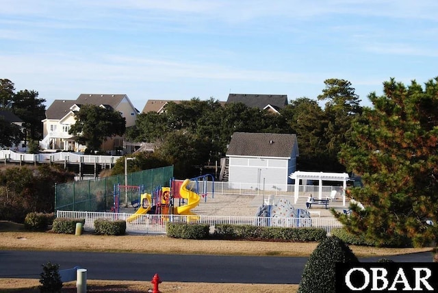 exterior space with playground community, fence, and a pergola