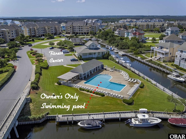 birds eye view of property with a residential view and a water view