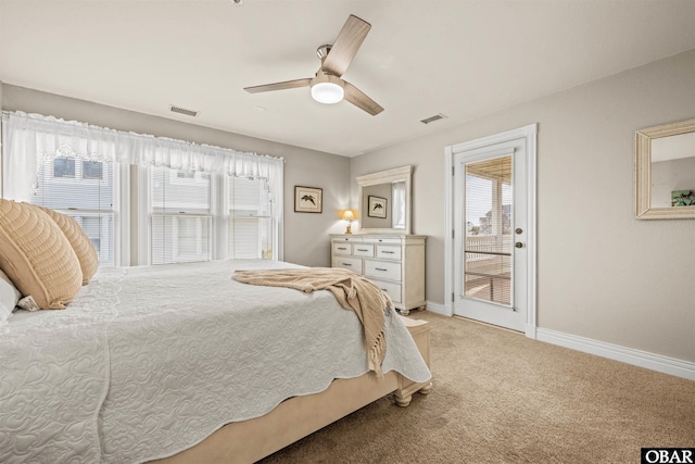 bedroom featuring light carpet, baseboards, multiple windows, and visible vents