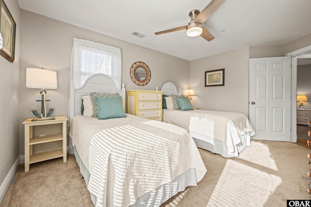 bedroom featuring light carpet, ceiling fan, visible vents, and baseboards