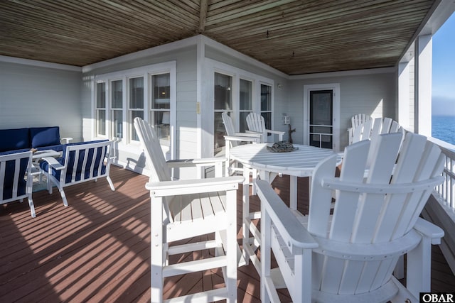 deck featuring a water view and outdoor lounge area