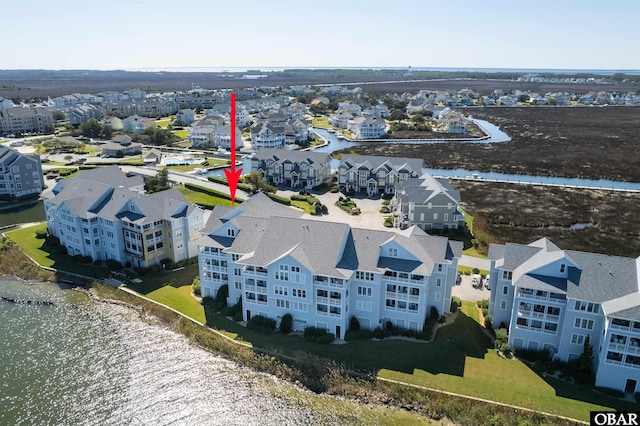 bird's eye view featuring a water view and a residential view