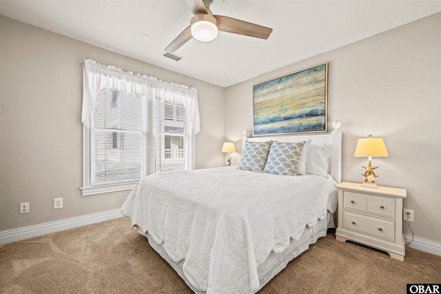 bedroom with a ceiling fan, light colored carpet, visible vents, and baseboards