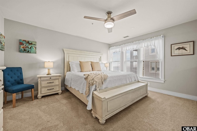 bedroom featuring a ceiling fan, light carpet, visible vents, and baseboards