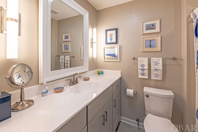 full bath with toilet, vanity, visible vents, and baseboards