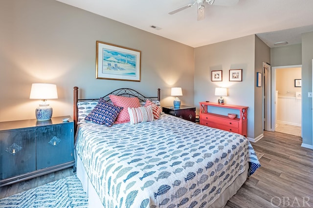 bedroom with ceiling fan, baseboards, and wood finished floors