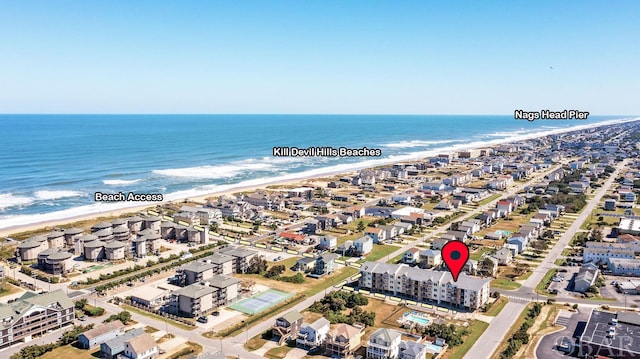 aerial view featuring a beach view, a water view, and a residential view