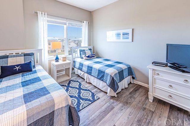 bedroom with light wood-style floors and baseboards