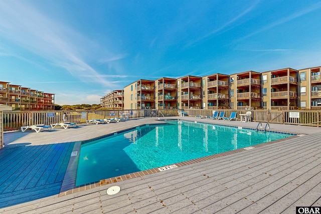 pool featuring fence and a wooden deck