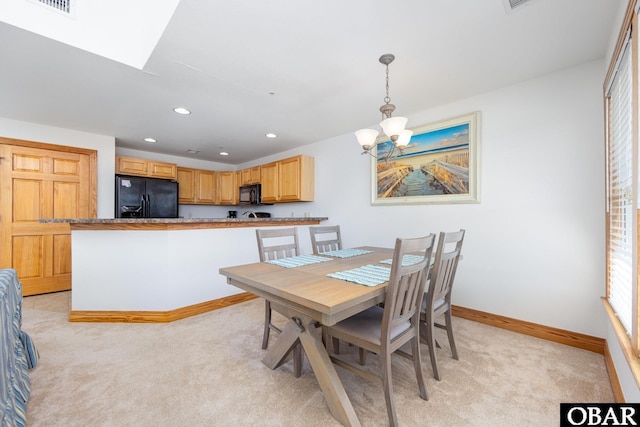 1700 Paget Rd Unit C 3, Kill Devil Hills, NC 27948 - dining area with light carpet, a chandelier, baseboards, recessed lighting, and a skylight