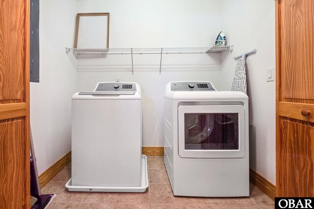1700 Paget Rd Unit C 3, Kill Devil Hills, NC 27948 - laundry room featuring separate washer and dryer, light tile patterned flooring, and baseboards