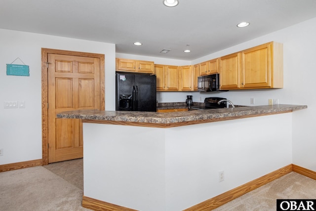 1700 Paget Rd Unit C 3, Kill Devil Hills, NC 27948 - kitchen with black appliances, baseboards, recessed lighting, a peninsula, and light carpet