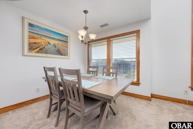 1700 Paget Rd Unit C 3, Kill Devil Hills, NC 27948 - dining area with a chandelier, baseboards, and light carpet