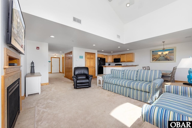1700 Paget Rd Unit C 3, Kill Devil Hills, NC 27948 - living room featuring a fireplace with flush hearth, light carpet, recessed lighting, baseboards, and a high ceiling