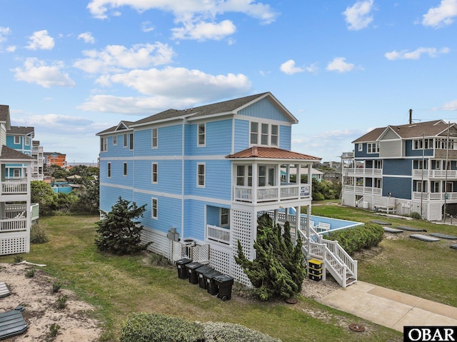24205 Caribbean Ct Lot 8, Rodanthe, NC 27968 - rear view of property with stairway, a lawn, and roof with shingles