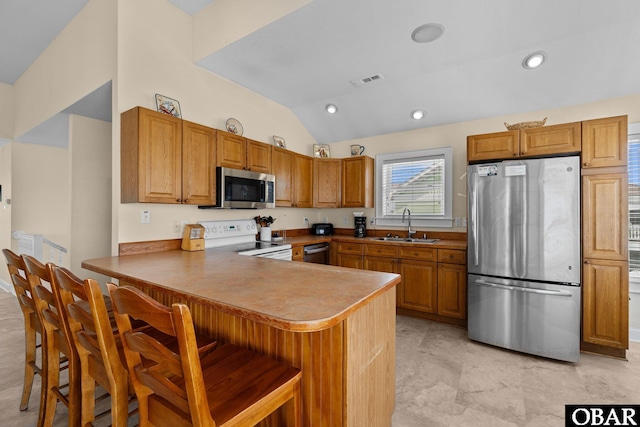 24205 Caribbean Ct Lot 8, Rodanthe, NC 27968 - kitchen featuring appliances with stainless steel finishes, a sink, a peninsula, lofted ceiling, and a breakfast bar area