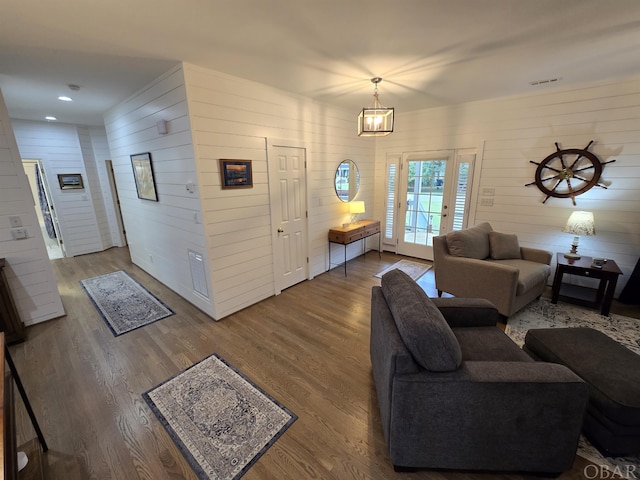 living room with wood finished floors, visible vents, and recessed lighting