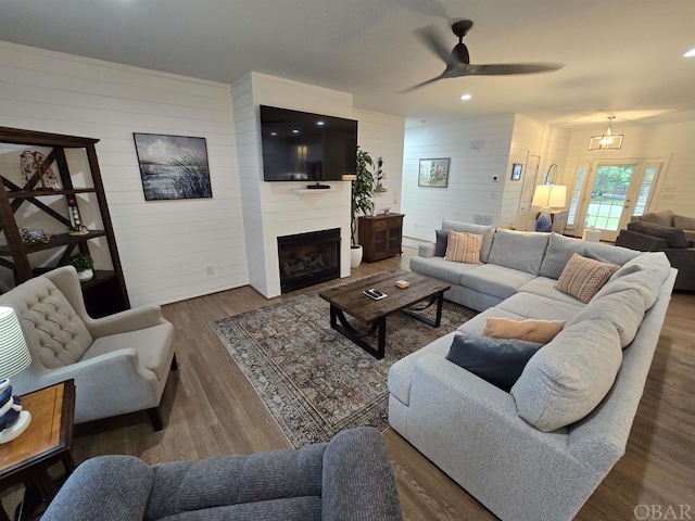 living room featuring dark wood-style floors, ceiling fan, a fireplace, and recessed lighting