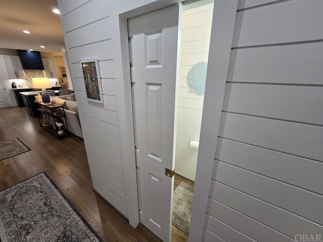 hallway featuring dark wood-style floors and recessed lighting