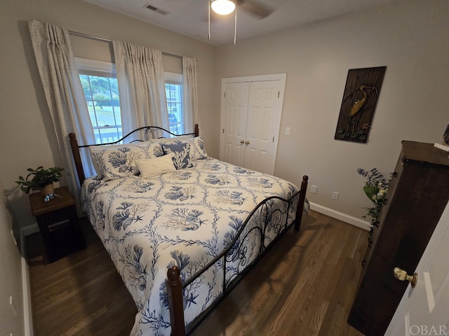 bedroom with ceiling fan, visible vents, baseboards, a closet, and dark wood-style floors