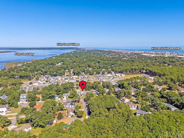 aerial view featuring a water view, a residential view, and a wooded view