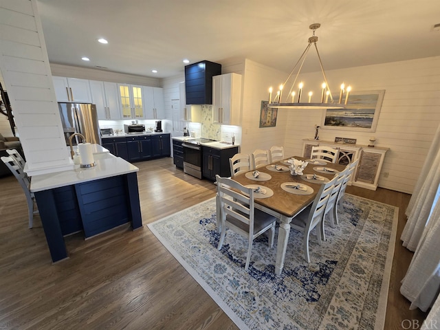 dining space featuring recessed lighting, wood finished floors, and a notable chandelier