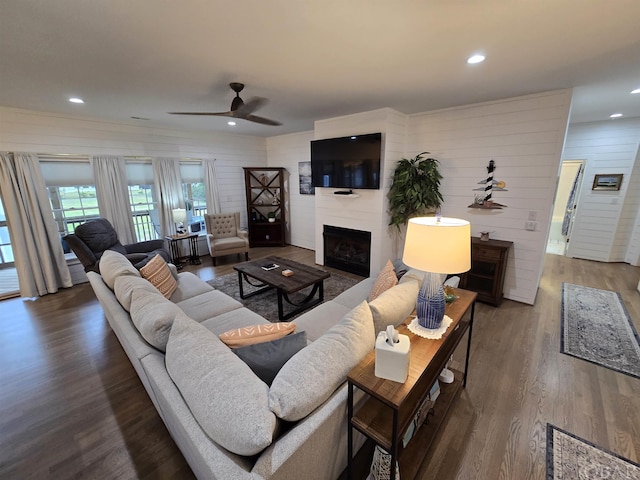 living area featuring ceiling fan, a fireplace, wood finished floors, and recessed lighting