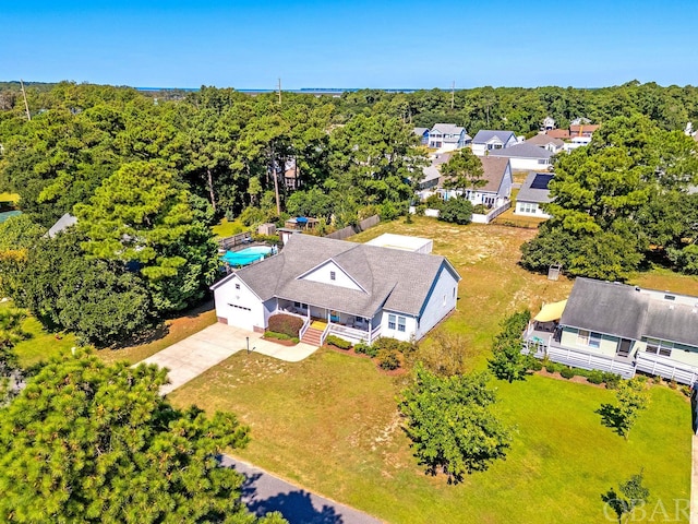 drone / aerial view with a residential view and a view of trees